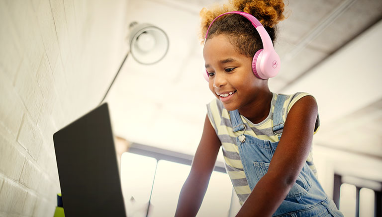Subject enjoying MOTO JR300 wireless kids headphones with Kid's safe sound limit