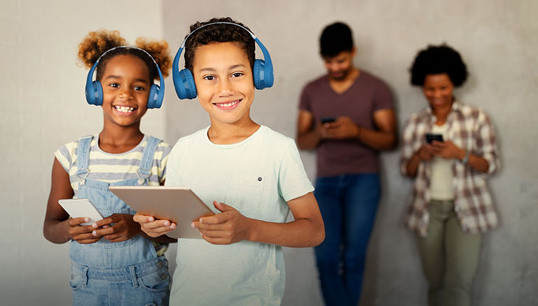 Subject enjoying MOTO JR300 wireless kids headphones with long hours playtime